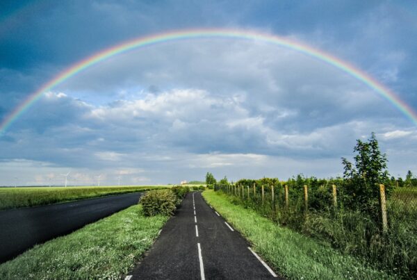 Rainbow arching over road